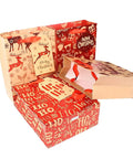 Christmas-themed gift bags with reindeer and 'Ho Ho Ho' patterns, open to display red interiors and handles.