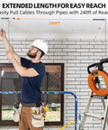 240 Ft Heavy Duty Flat Steel Fish Tape With Thumb Brake And Ergonomic Handle in use to pull cables through pipes.