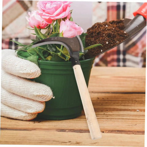 Portable Manganese Weeding Sickle with Non Slip Handle for gardening near pink flower in pot.