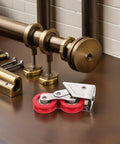 Heavy Duty Sliding Door Roller With Dual Nylon Wheels And Tough As Nails Stainless Steel Core Delivers Hella Smooth Glide Action and anti-slip rubber wheels on a workbench.