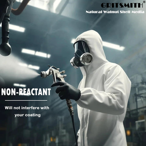 GRITSMITH Natural Walnut Shell Media label visible in a workshop; person in white protective suit and respirator holds a spray gun
