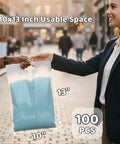 Person holding Frosted 10x13 Poly Mailers 100 Pack With Built In Handle Self Seal Matte Finish Shipping Bags on the street.