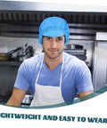 Blue Anti Static Work Caps 5 Pack Breathable Polyester Mesh Hat worn by man in kitchen, lightweight and sweat-resistant.