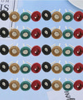 40 Piece Abrasive Nylon Buffing Wheels Set for Rotary Tools, showing four colored wheels arranged on a surface for display.