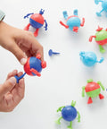 Prize Pod Robot Kit With 52 Piece Vending Machine Build Set And 12 Transforming Capsules, hands assembling capsule robot