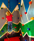 Gear Up And Crush Your Next Session With This Solid Rock Climbing Holds Kit Featuring Twenty Five Multi Colored Grips Paired With A Heavy Duty Knotted Rope Plus Full Mounting Hardware Ready For All Day Wall Workouts. Child climbing on colorful grips and rope on indoor wall.