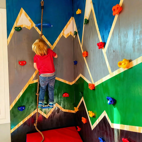 Gear Up And Crush Your Next Session With This Solid Rock Climbing Holds Kit Featuring Twenty Five Multi Colored Grips Paired With A Heavy Duty Knotted Rope Plus Full Mounting Hardware Ready For All Day Wall Workouts. Child climbing on colorful grips and rope on indoor wall.