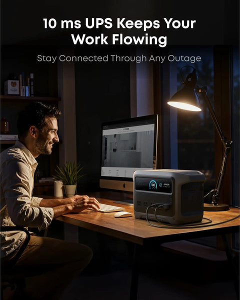 Man using computer with SOLIX C1000 Gen 2 Portable Power Station With 2000W Continuous Output 3000W Peak 1024Wh LiFePO4 Battery