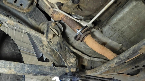 Top Tier Exhaust Flange Repair Kit For Jeep Wrangler JK and JKU 2012 to 2018 installed on exhaust pipe undercarriage.