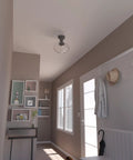 Saddle Creek Schoolhouse Style 1-Light Pendant With Noble Bronze Finish and Seeded Glass Shade in hallway ceiling.