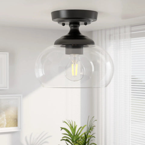 Industrial Semi Flush Mount Ceiling Light With Clear Glass Shade And Matte Black Finish in a modern living space.