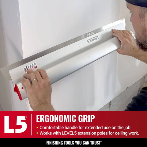 Person using 24-Inch Skimming Blade With 0.3mm German Stainless Steel Insert Replaceable Blade And Ergonomic Aluminum Profile for drywall