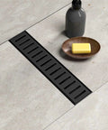24 Inch Sleek Black Linear Shower Drain With Removable Capsule Pattern Grate Rectangle Floor Drain In 304 Stainless Steel Adjustable Feet