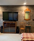 Slick Water Based Aging Wood Stain Yields Authentic Driftwood Gray Finish on interior wall with TV and rustic decor.