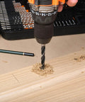 EnerTwist 246-piece drill bit set in plastic carrying case; metal twist drill bit drilling into wood.