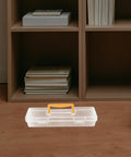 Heavy Duty Small Parts Organizer Box Built Tough Plastic Tool Caddy With Grippy Handle And Snappy Dividers on a wood floor near a bookshelf.