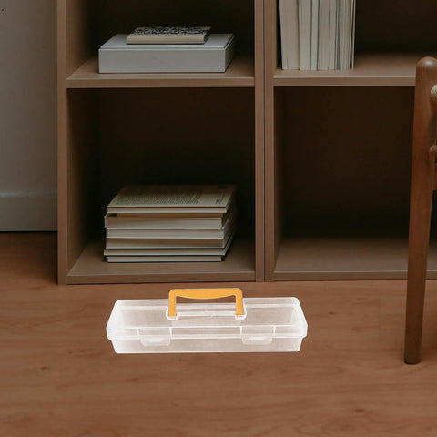 Heavy Duty Small Parts Organizer Box Built Tough Plastic Tool Caddy With Grippy Handle And Snappy Dividers on a wood floor near a bookshelf.