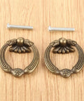 2 Pack Zinc Alloy Antique Bronze Drawer Handles for Furniture Cabinets and Doors Easy To Install with Screws Lightweight and Durable Perfect For Jewelry Boxes Wooden Boxes and Diy Projects, laid on a wooden background, with screws visible