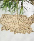 Wooden USA Map Wall Decor For Travel Buffs With All 50 State Abbreviations Engraved Ornament hanging on a tree branch