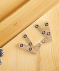 2 Pack Bronze Hidden Door Pivot Hinges on wooden surface for secret doors and cabinets