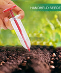 Handheld Seed Spreader And Manual Planter Tool With Ergonomic Grip for Lawn Backyard Garden Park And Outdoor Use Precise Planting Depth And Easy Spacing Reusable Dibber Style Seeder for Vegetables And Flowers in use on soil with seeds