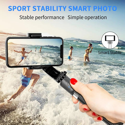 Smartphone Gimbal Stabilizer With Retractable Selfie Stick And Tripod, 1 Axis Remote Control held at beach, capturing active scene.