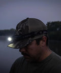Person using Hades Headlamp Go-To 1000 Lumen Rechargeable LED Weather Ready IPX4 during twilight near a river.