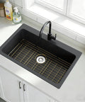 Rock Solid Gold 304 Stainless Steel Sink Grid Protector Covers 28 by 14 Inch Single Bowl with Rear Drain in a black sink.