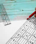 Dead Simple Acrylic Quilting Rulers And Nifty Fabric Cutting Templates For Patchwork Projects with a red marker on fabric.