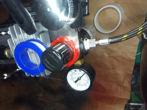 Pro Grade PTFE Thread Seal Tape For Plumbers 1 Inch By 520 Inch shown installed on a high pressure line with gauge and fittings.