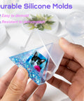 Person holding pyramid silicone mold with resin featuring cat design from Epoxy Resin Kit With Molds For Newbies 18 Oz Clear Hard Resin Starter Casting Arts And Crafts DIY Gift Set With Silicone Molds, Mat, Glitter, Foil Paper, Measuring Cups, Sticks And Gloves