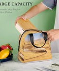Person placing lunchbox into Golden Sand Desert Insulated Lunch Tote With Aluminum Lining On The Go Lunch Box For Work Travel Beach Camping Durable Polyester Bag For Women And Men Lightweight Durable Design For Everyday Use on table