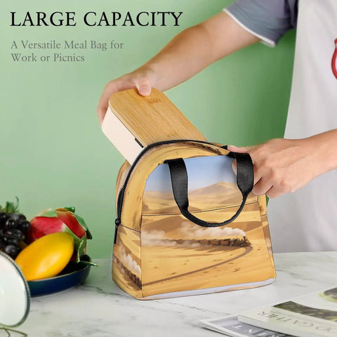 Person placing lunchbox into Golden Sand Desert Insulated Lunch Tote With Aluminum Lining On The Go Lunch Box For Work Travel Beach Camping Durable Polyester Bag For Women And Men Lightweight Durable Design For Everyday Use on table