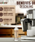 Universal Descaler For Keurig Nespresso Delonghi And All Single Serve Coffee Makers 2 Pack With 4 Uses Made In USA bottle next to coffee machine