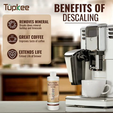 Universal Descaler For Keurig Nespresso Delonghi And All Single Serve Coffee Makers 2 Pack With 4 Uses Made In USA bottle next to coffee machine