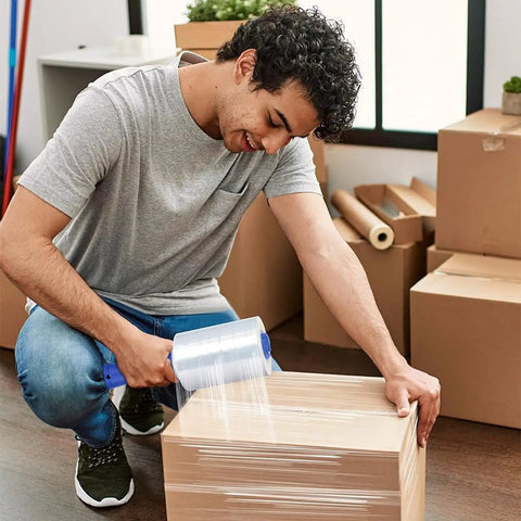 Man using Industrial Grade Clear Hand Stretch Wrap Film Two Pack Eighty Gauge Six Inch Wide One Thousand Feet Heavy Duty Packing Rolls.