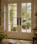 Black 9 Inch Flat Iron Barn Door Pull on french doors, wrought iron finish, visible from rustic interior