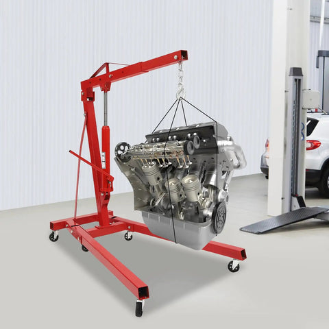 Heavy Duty Folding Hydraulic Engine Hoist Built Tough As Nails With Six Swivel Casters lifting a car engine in a shop setting.