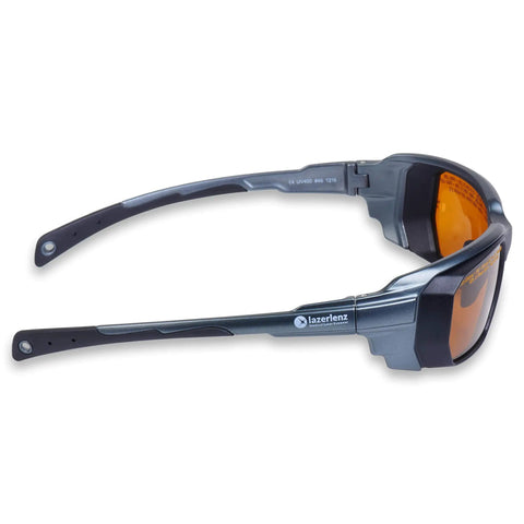 High Grade Laser Safety Eyewear For Tattoo Removal, Vein Removal, And Pigmented Lesion Treatments With 190 To 534 Nm And 850 To 1064 Nm Filters, Wraparound Eye Frames For Docs And Laser Pros, ANSI Z136.1 Certified, side view with orange lenses