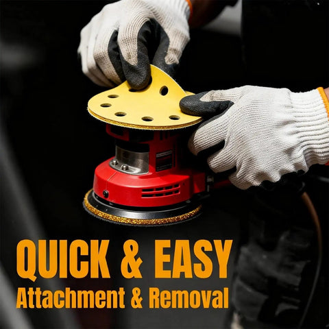 Gloved hands attaching 5 inch 8 hole sanding disc to random orbital sander, part of Dustless Sanding Discs Set 50 Pcs