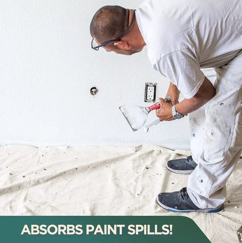 Man painting with Heavy Duty 12oz Cotton Duck Canvas Drop Cloths, 6-Piece Set spread on floor to catch paint spills.