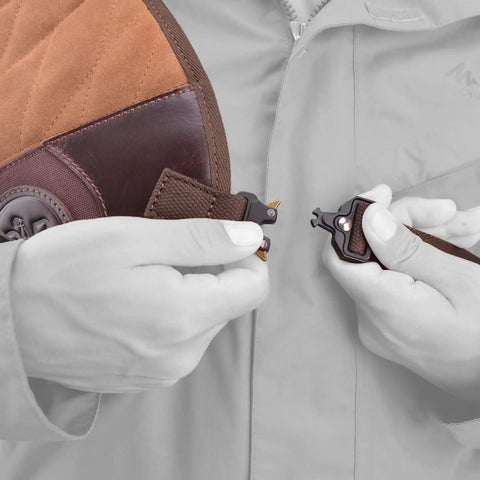 Hands adjusting shoulder strap on Adjustable Rifle And Shotgun Field Shield Recoil Pad With Leather Shirt Vest for secure fit.