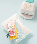 3-In-1 Round Tag Punch for Crafting and Scrapbooking, multi-color tool shown with gift tags and decorative designs.