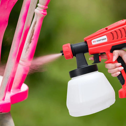 Cordless HVLP Paint Sprayer With 1300ML Cup 3 Spray Patterns And 4 Nozzles Easy Clean Joints spraying pink paint on furniture