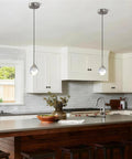MKonpeny Modern Crystal Moon Pendant Light, 3000K 7W led pendant light kitchen island in a stylish kitchen.