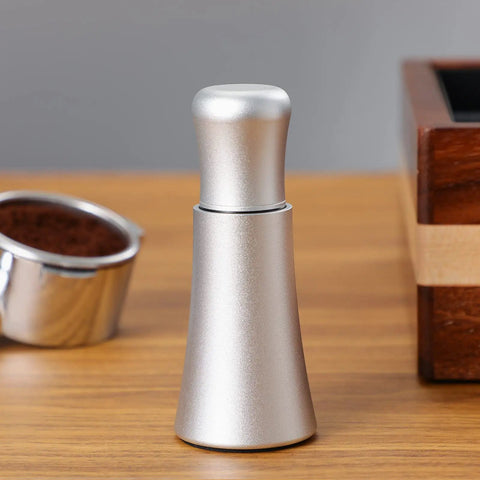 Espresso Distribution Tool With 10 Needle 0.35mm Precision Stirrer Matte Black Finish on a wooden table next to espresso cup