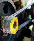 Close-up of a pulley with a yellow center, connected to a 2 Pack M-21 Rubber V Drive Belt 21 Inch Pitch Girth for industrial machinery.