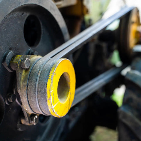 Close-up of a pulley with a yellow center, connected to a 2 Pack M-21 Rubber V Drive Belt 21 Inch Pitch Girth for industrial machinery.
