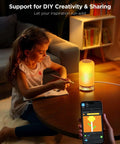 Lit RGBIC Smart Table Lamp 2 with touch control and 64 scene modes on a desk, child drawing, room in soft lighting, phone app visible