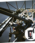 Close-up of a bike wheel with disc brake showing Hydraulic Hose Fitting Insert Tool For Bicycles With Needle Driver And Detachable Thimble Lock